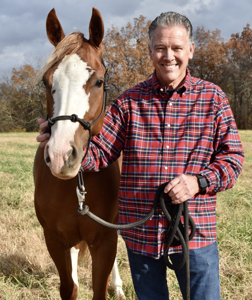 Dr. Stan Snodgrass and a horse in a field